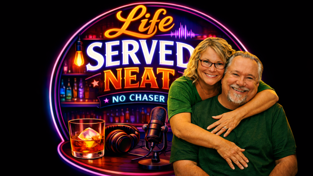 Howie and Elizabeth Barber in the Life Served Neat podcast studio with neon sign, microphone, and whiskey glass representing real conversations and no-nonsense perspective