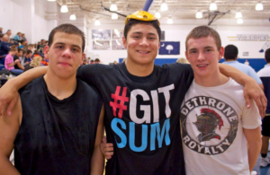 High school wrestlers Louis Esposito, Michael Macchiavello, and Brett Barber together at a wrestling event.